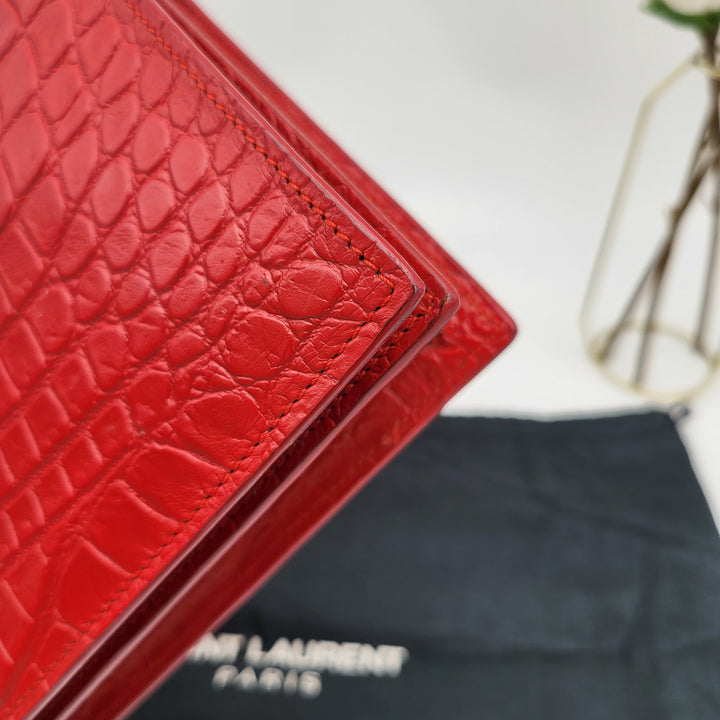 YVES SAINT LAURENT EMBOSSED CROC LEATHERCLUTCH